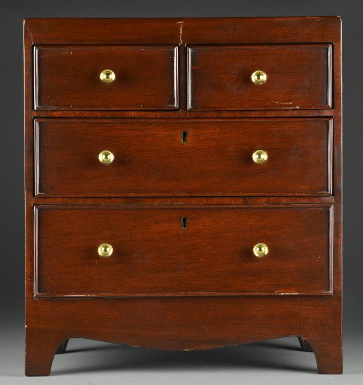 A Miniature Chest of Five Drawers: In the Sheraton style having two small drawers over two large drawers, having cock beaded edges, brass pulls and faux key escutcheons, 18.25"H x 16"W x 9.5"D, circa 20th century. Property of a private