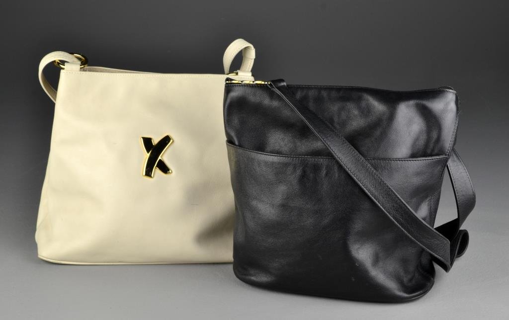 (2) Paloma Picasso X Handbags: One cream leather shoulder bag with X to front, having two interior sections and one zippered section; together with a black leather shoulder bag having X accents, with one exterior compartment and in