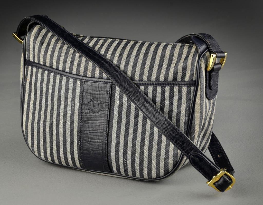 Fendi Navy Canvas Bag: Having one exterior open compartment, interior with zippered compartment, retaining original dust cover bag, measures 7.5"H x 9.5"W, measures 27"L to top of strap. Condition: with some staining to ext