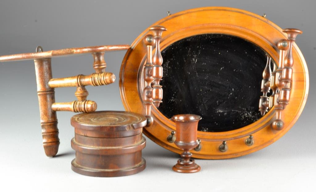 (4) Pcs Turned Wood Treenware: To include a round covered box, egg cup, hanging wall shelf and a mirror with swiveling wood and attached metal coat hooks, each with turned elements, largest measures 13.5"W, circa 20th century. Cond