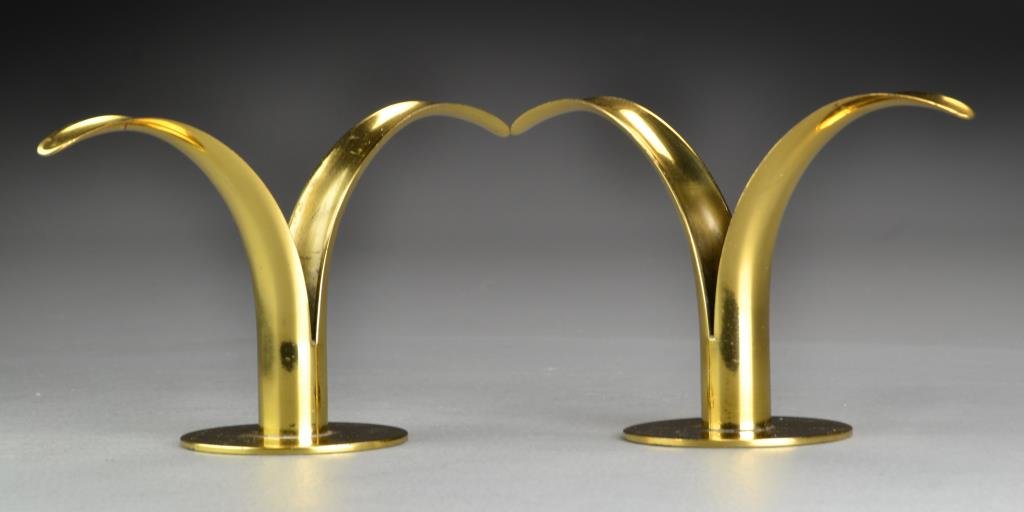 Pr. Swedish Ystad Brass Candlesticks: Pair of Ystad Lilly brass candlesticks, undersides marked Ystad-Metall, Made in Sweden, with initial marks for designer Ivar Alenius Bjork, measure approximately 4.75"H x 8.5"W, circa 1950. Condition: