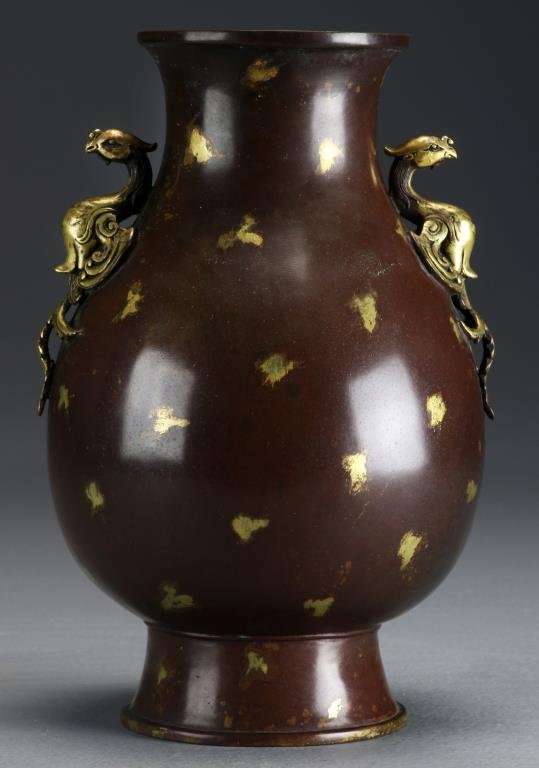 A Fine Chinese Gold Splashed Bronze Vase: Of archaic from, having gilt phoenix handles and gold splashes throughout, with molded dragons surrounding a seal mark to underside, measures 9.5"H. Property of a Birmingham, MI lady.