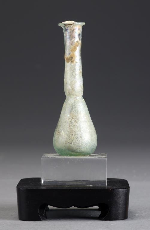 Ancient Roman Glass Vessel: A small Roman bottle neck glass vase, raised on Lucite stand, 3.5"H not including stand, circa 27 B.C. -393 A.D.