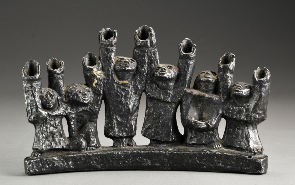 WWII Era Bronzed Menorah: A cast bronzed metal figural menorah, the raised hands as candle holders, measures 6.75"H x 11.5"W. Condition: having overall surface wear.