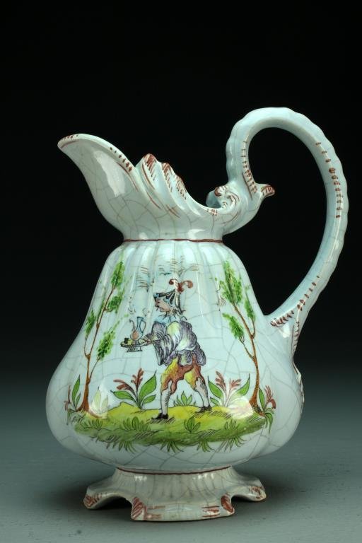 A Fine Antique Pivato Nove Italian Faience Handled: Finely decorated to depcit a male figure within a wooded landscape, bulbous in shape having a scrolled rim and ribbed shoulder, signed "Pivato Nove" to base under glaze, measures 9"H, circa late 19th-