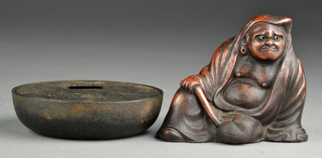 (2) Chinese Qing Metal Decorative Objects: To include a scholar holding a scepter, having a bronzed patina and impressed stamp to reverse, 4"H, together with an iron covered box having impressed character marks to top of lid, 4.5"Dia., both ci