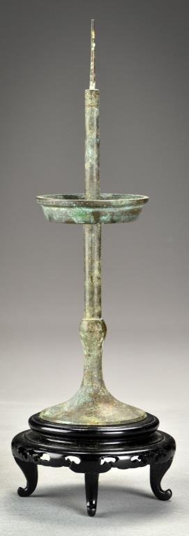 A Chinese Ming-Qing Bronze Candle Pricket: Of simple form now raised on a later hardwood stand, 11.5"H not including stand, circa Ming or Qing Dynasty. Property of a private Michigan collector who collected these pieces in the 1980's. Some of 
