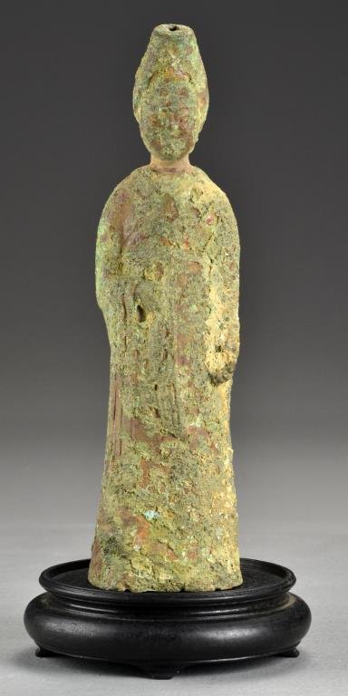 A Chinese Shang-Zhou Style Bronze Statue: Appears to be formed as a court official wearing long flowing robes and holding an object in his hand, now raised on a later hardwood stand, 10.5"H not including stand, Shang-Zhou style and possibly o