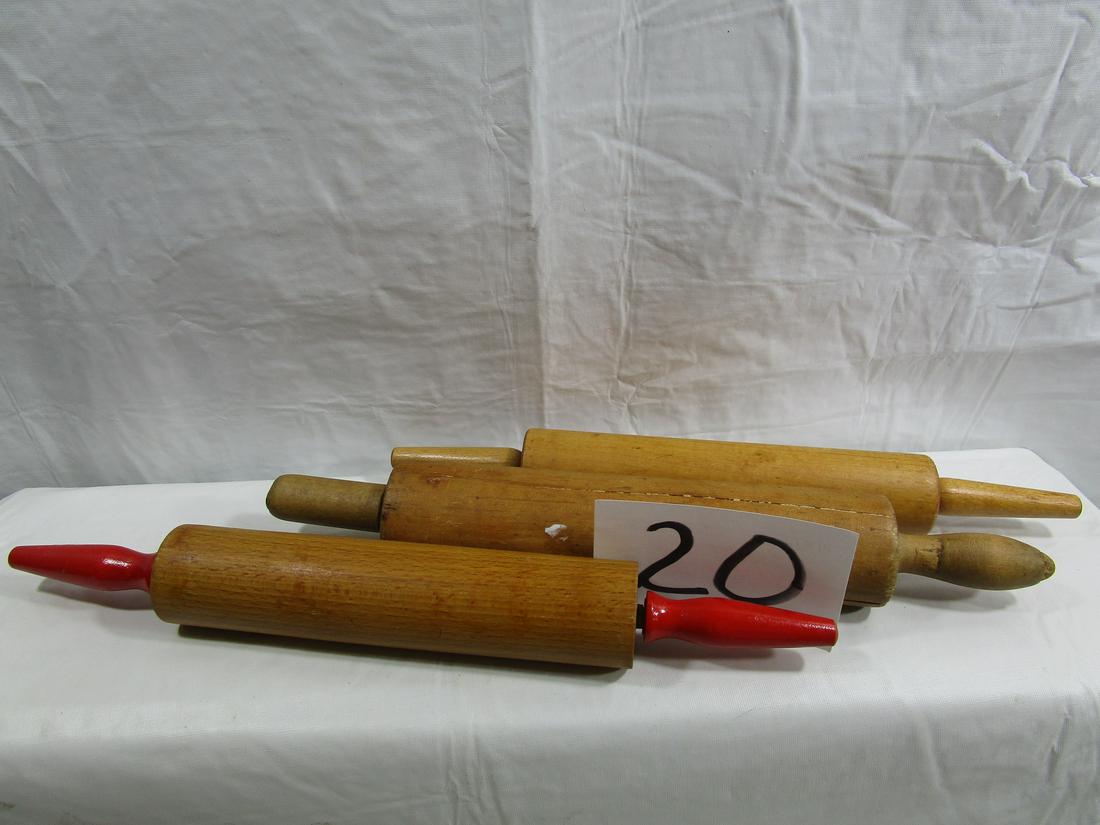 Lot of 3 Vintage Rolling Pins: This lot includes 3 rolling pins all made of wood. One has red wooden handles on the side. Another is slender and the last one is thick and fat. The larger one has a crack running along the length of 