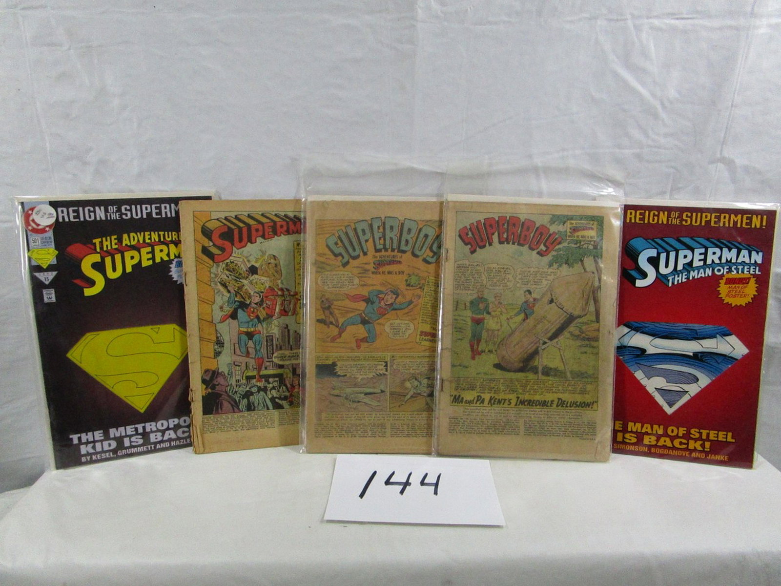 Lot Of 5 Superboy Superman Comic Books: This lot of comic books are in decent condition. The older ones are dated 1956, 1958 and 1962. One of them is not in a protective sleeve and shows some damage along the stapled edge.