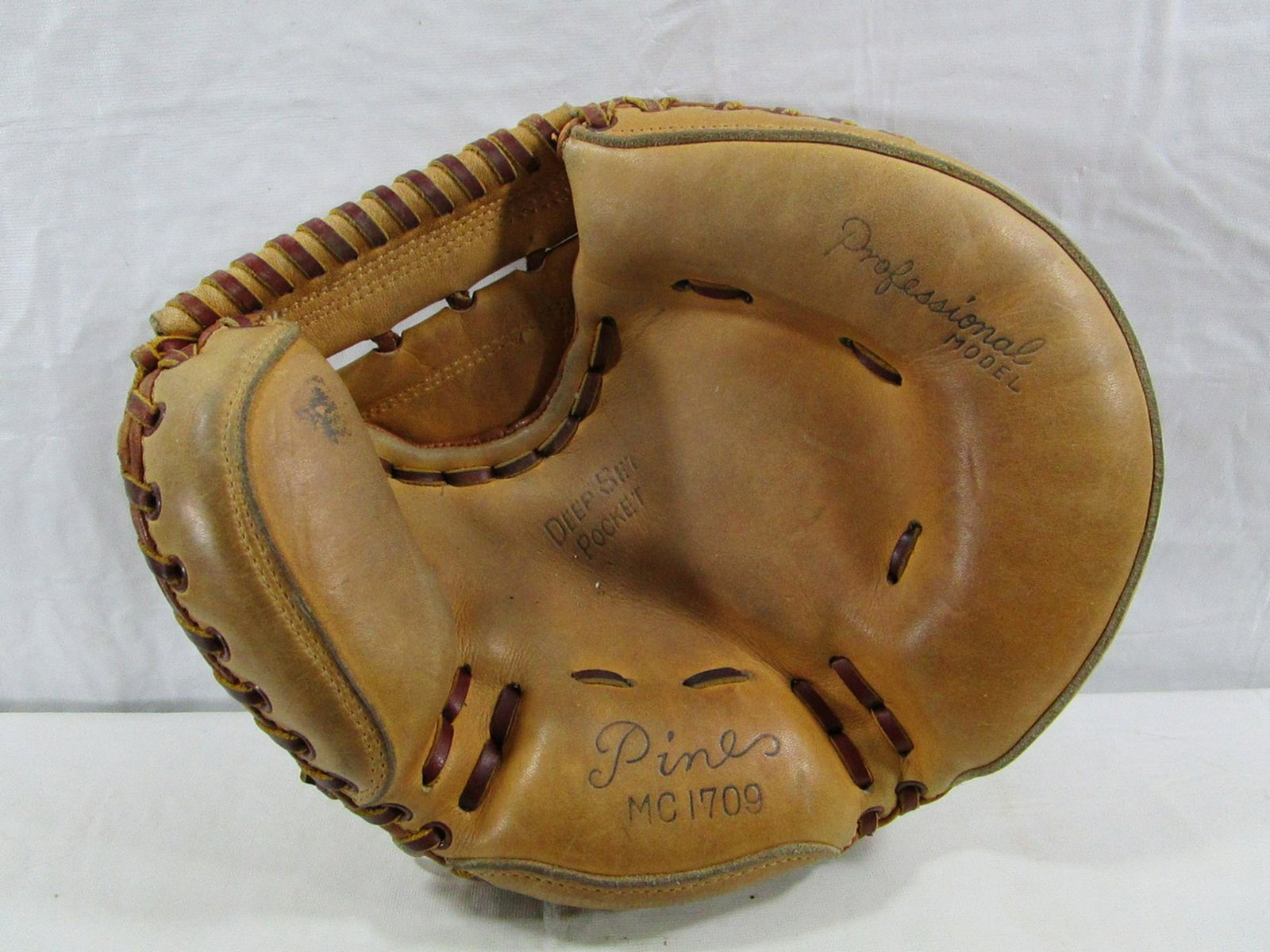 Professional Model Pines MC1709 Baseball Catchers Mitt: The glove is deep pocket style and in very nice condition. This is a nice catcher's mitt.
