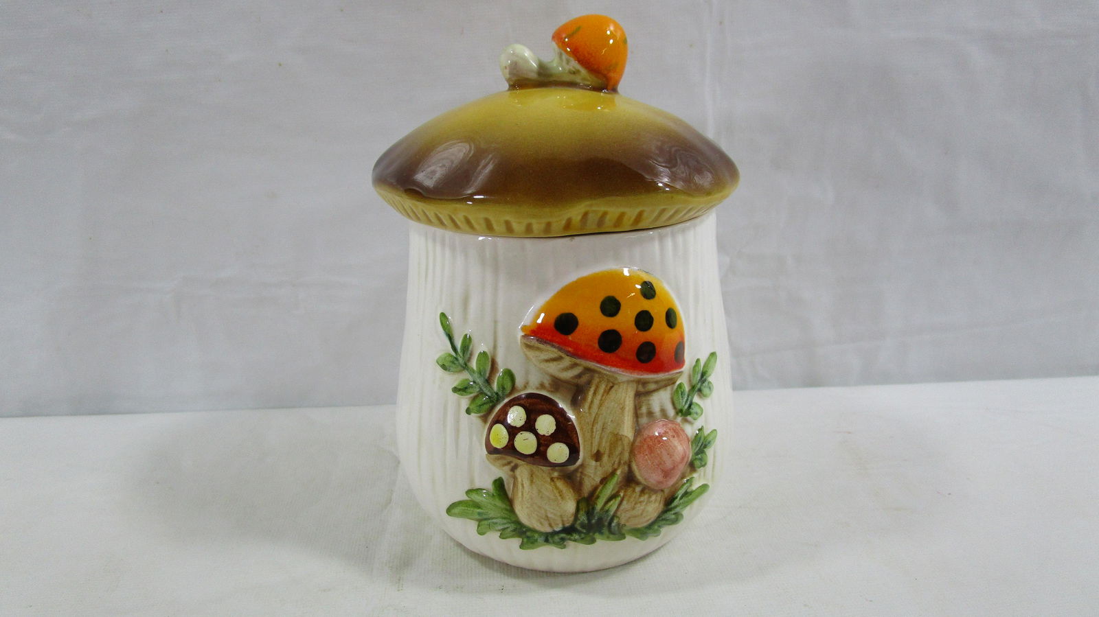 Vintage Merry Mushroom Sears Roebuck Canister: This small canister is about 6.5" tall to the top of the finial on the lid. It has no chips, cracks or any other damage.