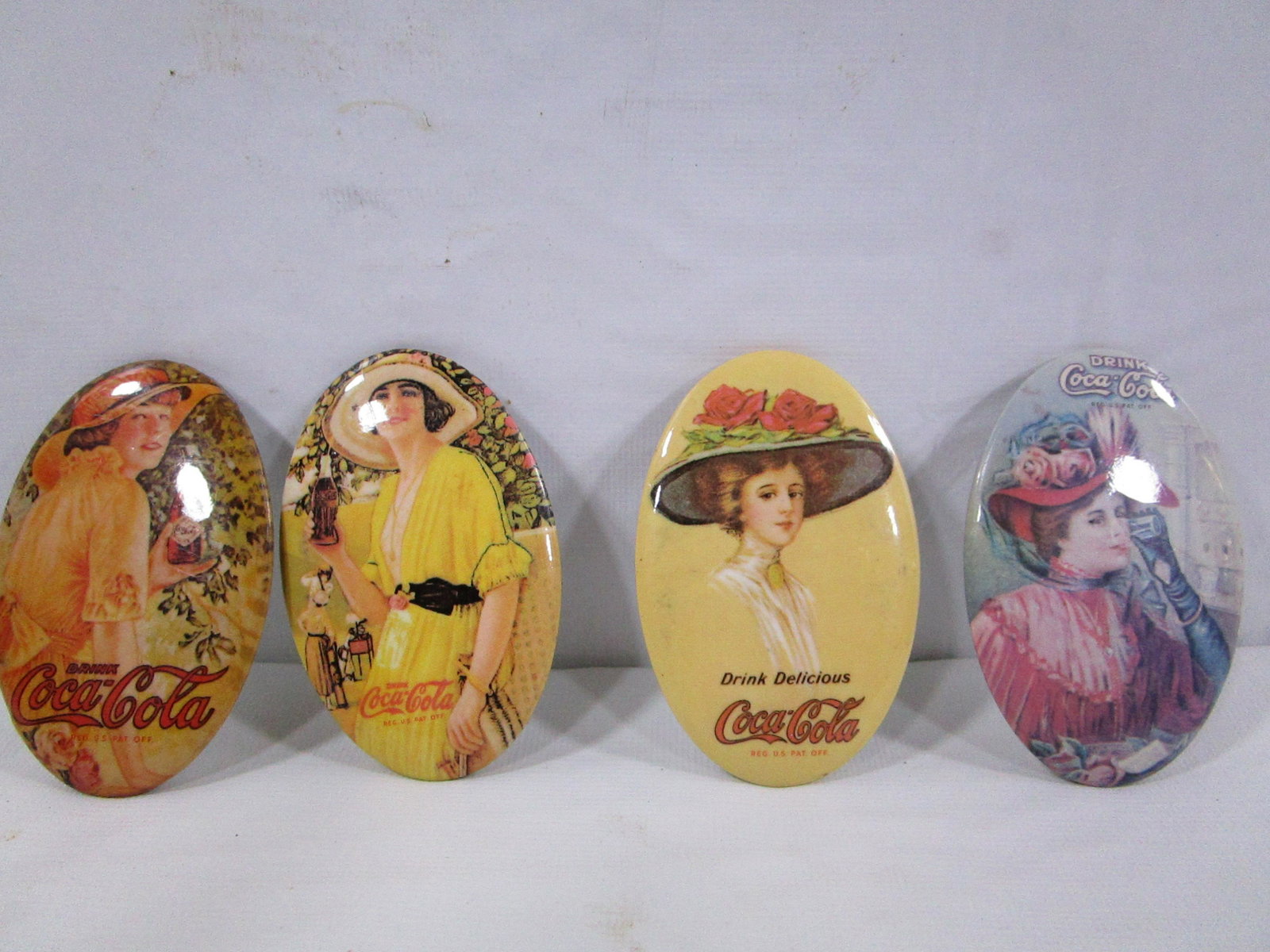 Vintage Style Coca-Cola Metal Button Mirrors: These little mirrors have images from older Coca-Cola advertisements. They all have a mirror on the back. They are about 2 3/4" tall and 1 3/4" wide. Very nice condition. No color loss or other damage