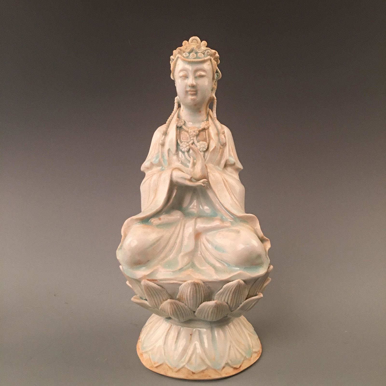 Chinese Longquan Kiln Seated Guanyin Figure: Chinese Longquan Kiln Seated Guanyin Figure 11-1/4'' H, 5-3/8'' W; 3.2 lb Shipping: We are able to pack and ship this item to an address in the United States via UPS Ground or USPS Priority Mail for $