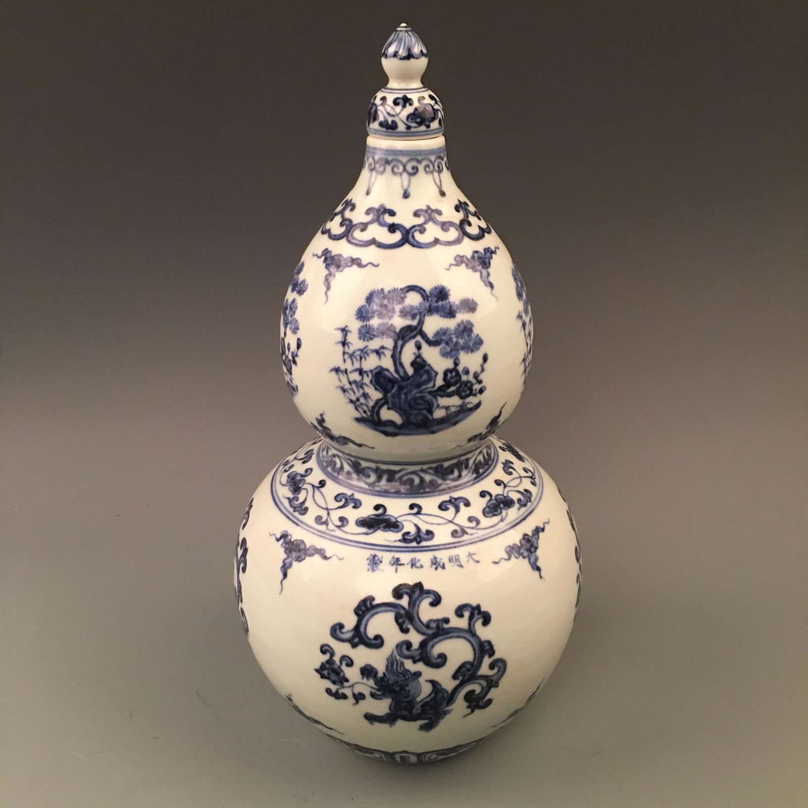 Chinese Blue-White Gourd Wine Bottle with Cover: Chinese Blue-White Gourd Wine Bottle with Cover 'Chenghua' Mark 14-1/2'' H; 7-1/4'' W; 4.4 lb Shipping: We are able to pack and ship this item to an address in the United States via UPS Ground or USPS