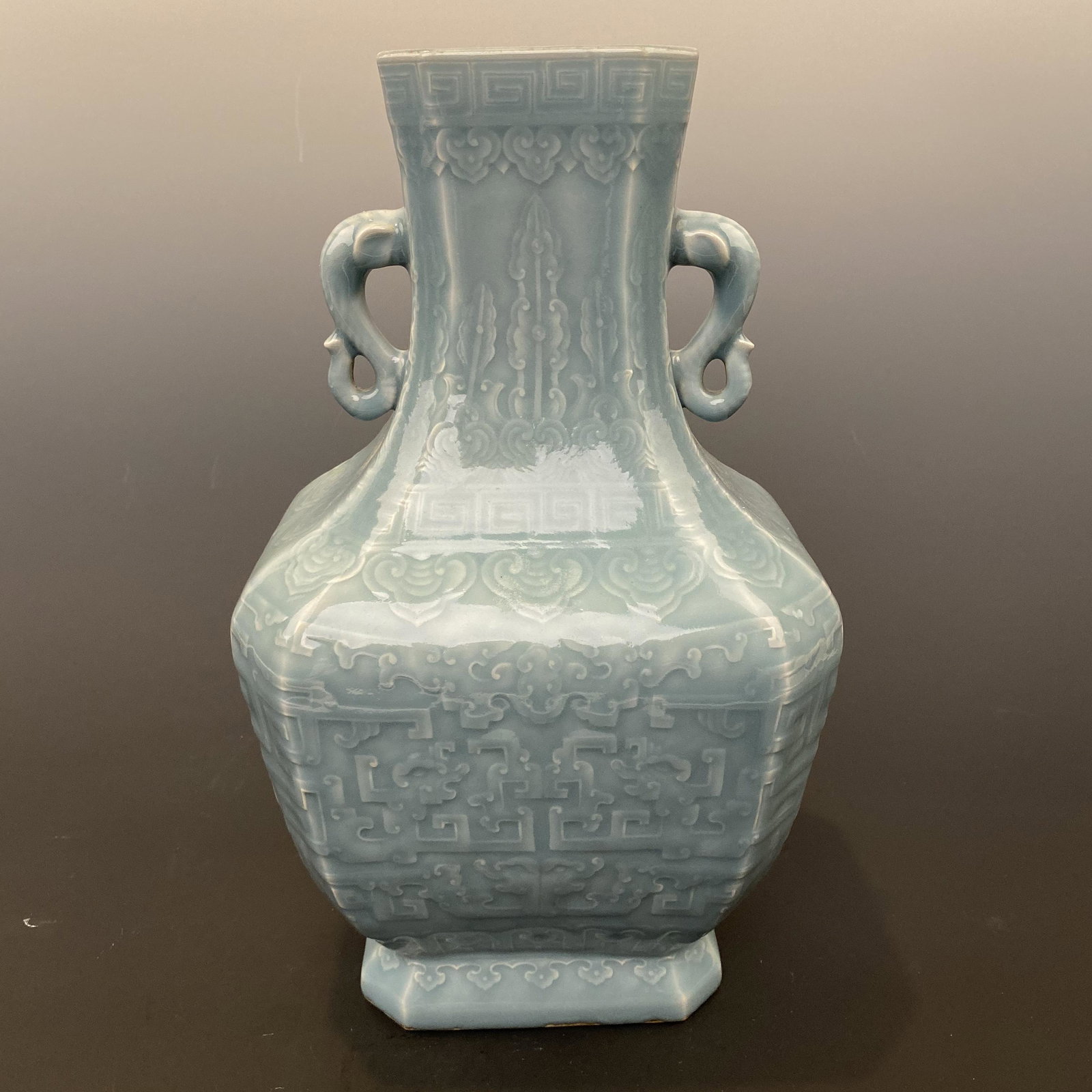 Chinese Hutian Kiln Engraved Square Vase with Elephant: Chinese Hutian Kiln Engraved Square Vase with Elephant Handles 'Qianlong' Mark 13-7/8'' H; 8-1/4'' W; 6.8 lb Shipping: We are able to pack and ship this item to an address in the United States via UPS