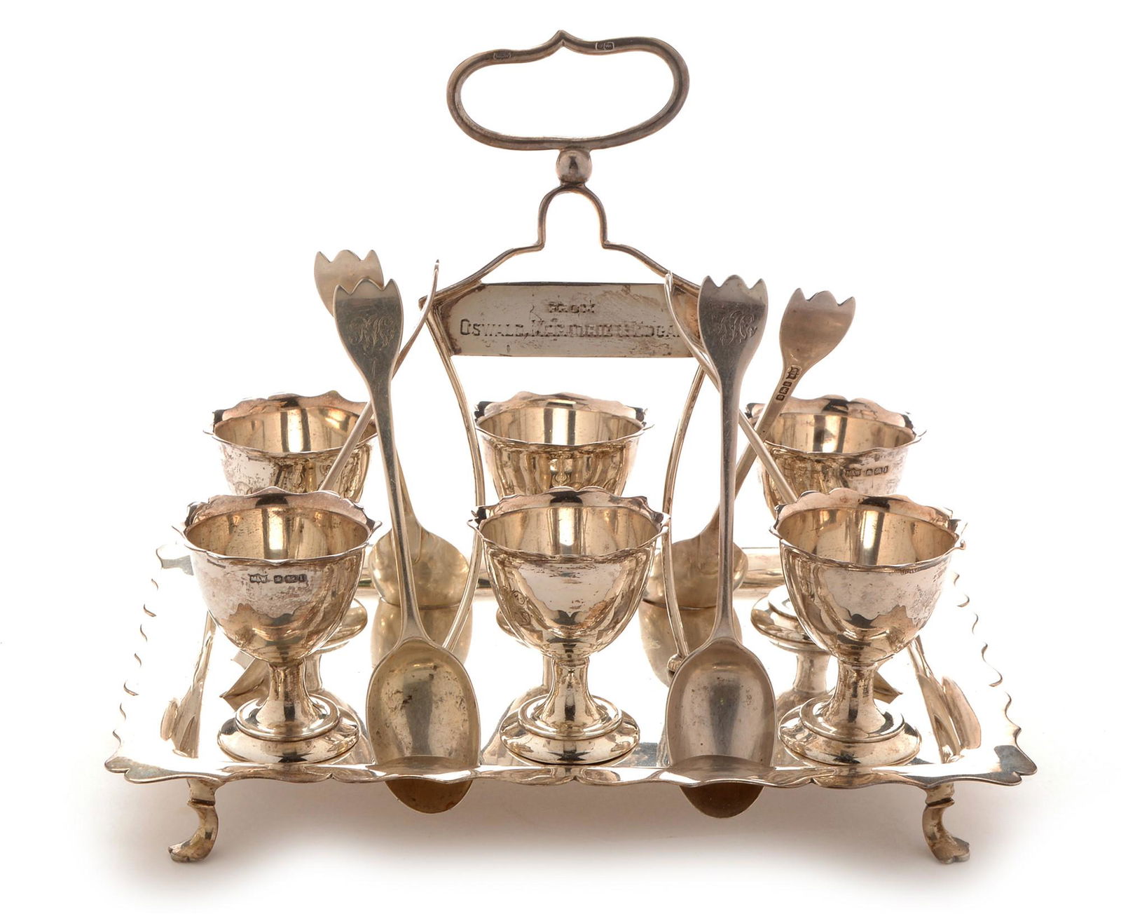 Silver cruet set: An Edwardian silver egg cruet set, by Mappin and Webb, Sheffield 1903, comprising stand with presentation inscription handle, egg cups and teaspoons with engraved monograms, 21 x 15 x 18cms high, 28.7