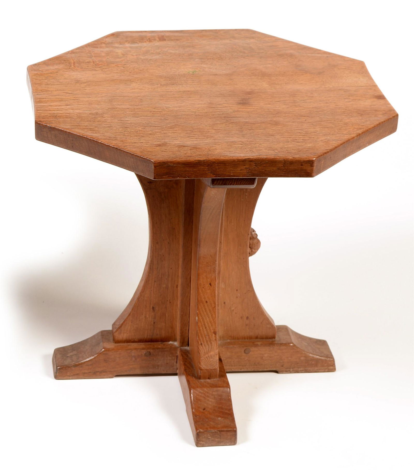 Mouseman: a Robert Thompson of Kilburn oak occasional: Mouseman: a Robert Thompson of Kilburn oak occasional table , with octagonal adzed top and raised on concave supports, with carved signature mouse, 50cms x 47cms high. Sale Section/Category: Furniture