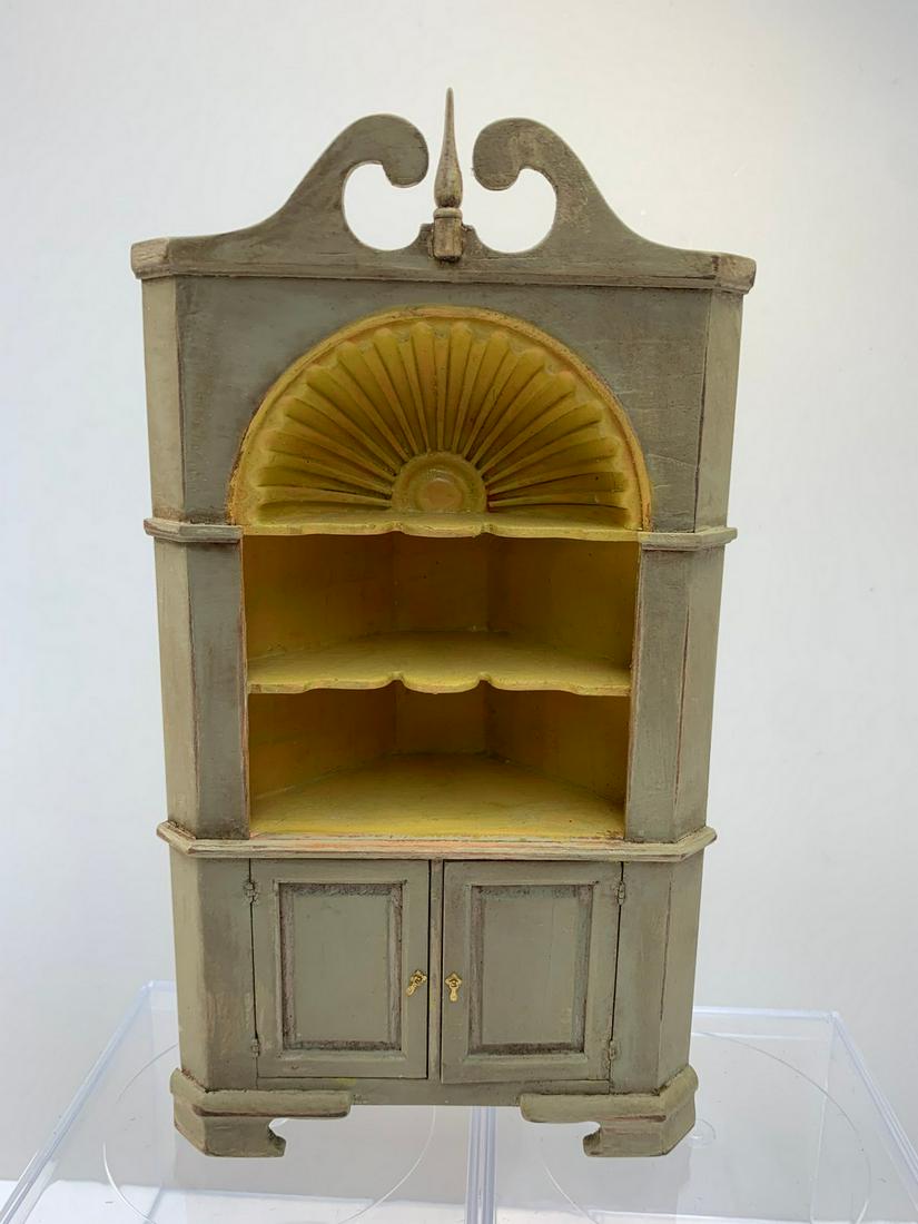 IGMA Artisan Ted "Ed" Norton Corner Cabinet: Handmade corner cabinet by Ed Norton, IGMA artisan. The cabinet is painted a historical green color with the inside painted golden. The doors have brass hardware and the bottom is signed. 1:12 dollhou