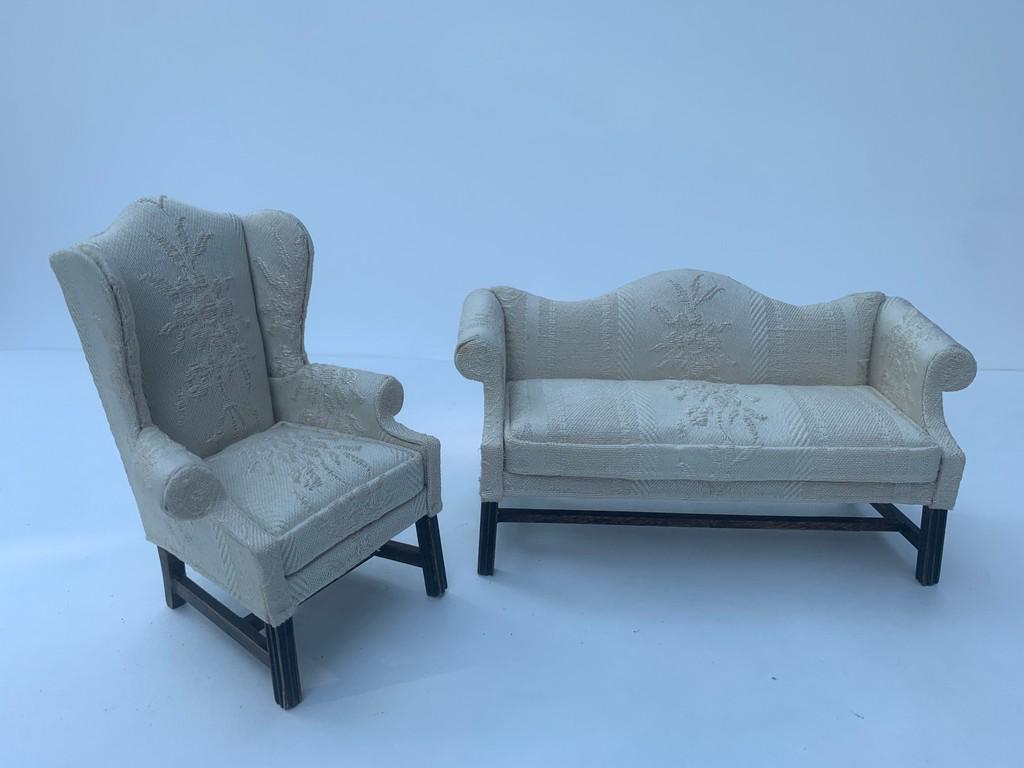 Nellie Belt Couch & Armchair Set of 2: Nellie Belt made this sofa and chair set. The fabric is off white with a slight marking from glue. Wooden feet and base. Glue repair to one of the stretchers of the sofa. Signed. Measurement for sofa.