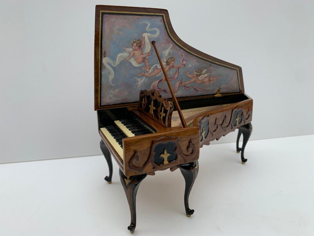 Ralph Partelow Fleur de Lis Harpsichord w/Cherubs: This is a hand crafted Fleur de Lis Harpsichord with painted cherubs by Ralph Partelow. This harpsichord is made of walnut and is an 18th century version. There's a bench to match. From the personal e