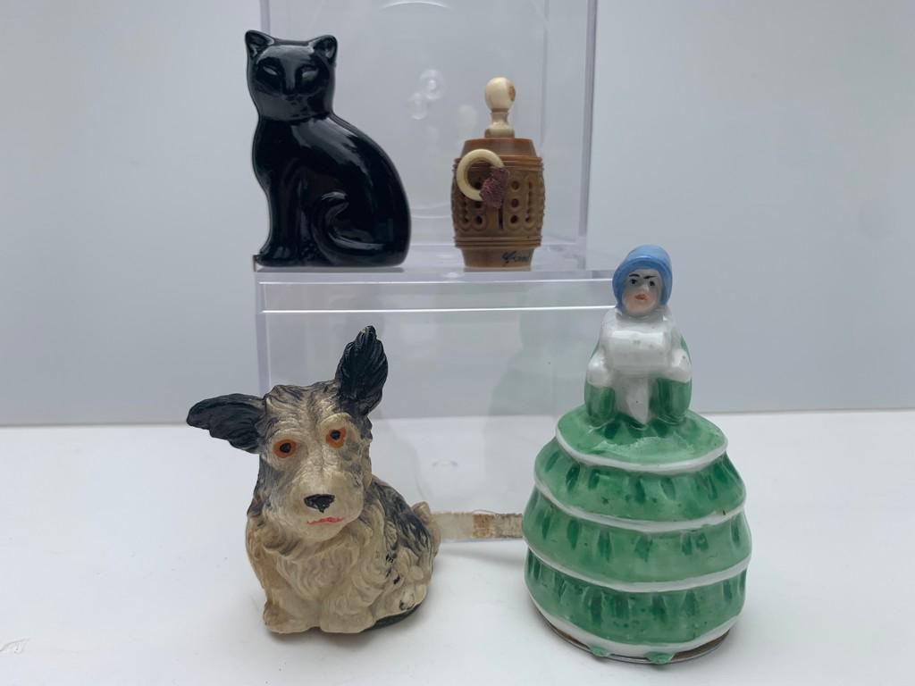 4 Pc. Lot w/ Porcelain Lady Tape Measure Germany: This is a lot of 4 tape measures with shapes of a cat, a dog, a barrel and a porcelain woman doll from Germany. The cat is a black cat, the dog is plastic and the barrel is from Canada. Barrel measure