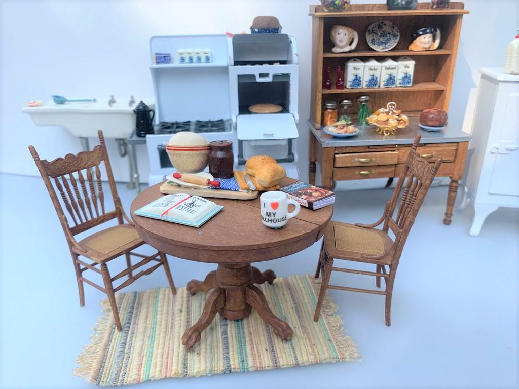 1930's Large Kitchen Lot w/ Hoosier Cabinet: This is a large kitchen lot based on the 1930's. There's a Hoosier cabinet made of wood and the bottom drawers open to have bins. There's accessories decorating the piece as well. There's a round tabl