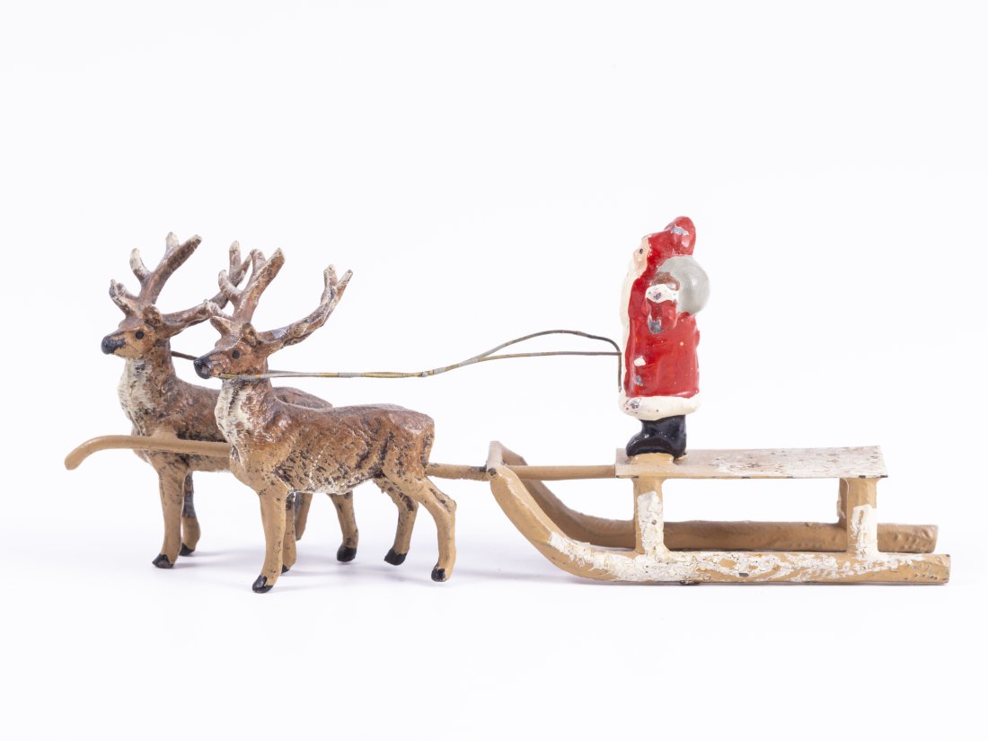 Vintage Metal Santa Riding Sleigh w/ 2 Reindeer From Germany: Vintage metal Santa Claus figure riding on a sleigh. The sleigh is being pulled by 2 reindeers. Marked Germany underneath. 4 3/4" W x 3/4" D x 1 7/8" H