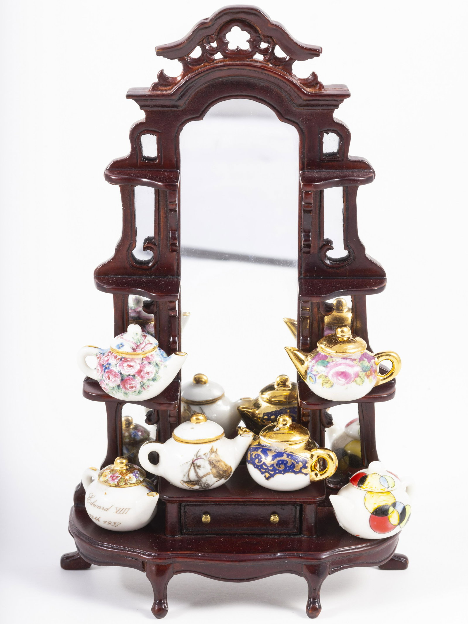 Teapots by Rachel Munday - A Woman's Touch with Mahogany Display: A nice variety of six hand decorated porcelain teapots by A Woman's Touch in England. The teapots have removable lids and are decorated on this large mirrored mahogany Bespaq display.
