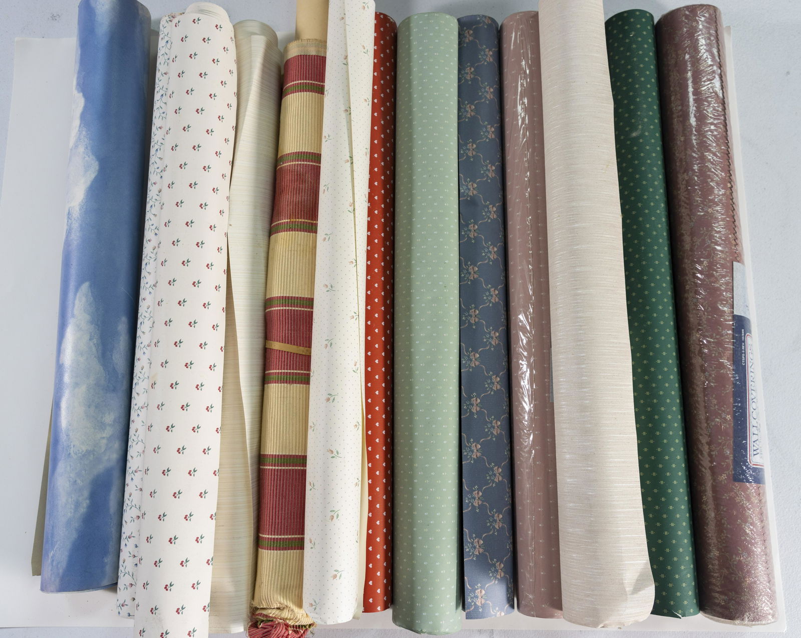 This is a variety of large rolls of wallpaper in different patterns and textures.  Lots of paper to (1 of 4)