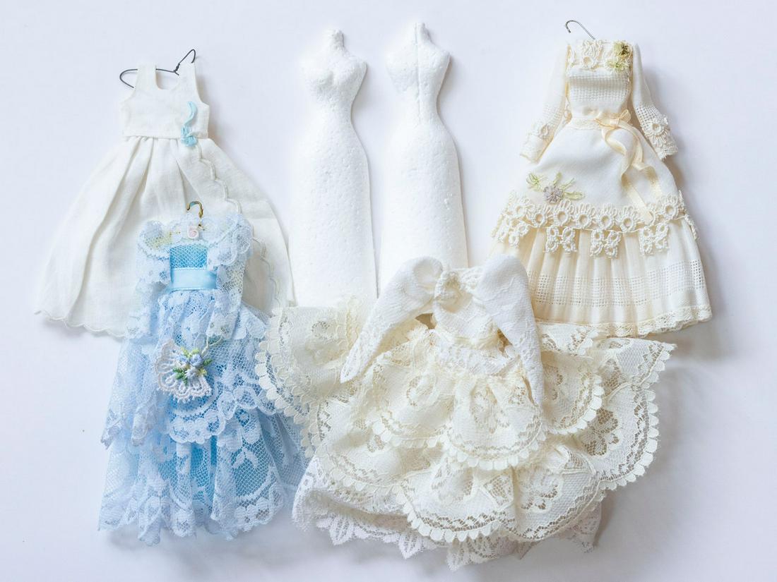 4 Handmade Dresses With Dress Forms: 4 Handmade Dresses With Dress Forms. i) Lace wedding dress, ii) Cream and Lace Handmade Dress with flowers, iii) Blue Dress with Lace, and iv) White Dress.White dress measures approximately 4 1/2" H