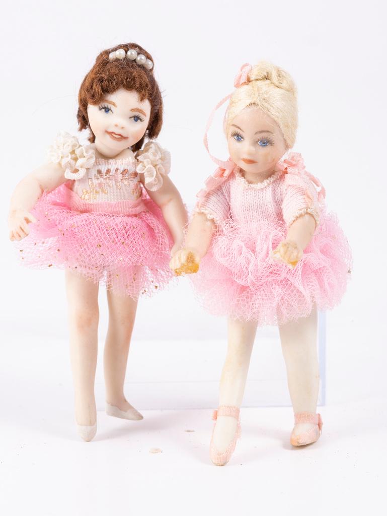 Two Little Girl Ballerinas in Pink: So cute, these two little girls are wearing pink tutus. One doll has blonde hair, the other brown hair. The little girls are ready to perform.
