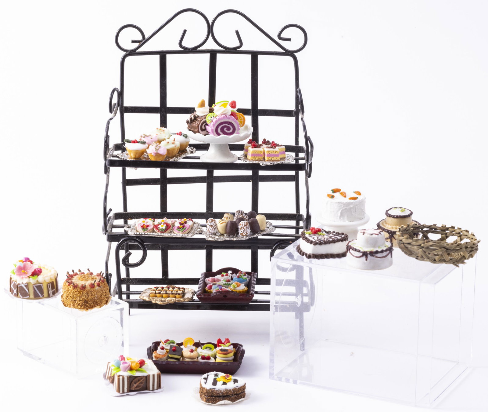 Bakers Rack Filled with Assorted Cakes & Pastries: Bakers Rack Filled with Assorted Cakes & Pastries. No calories! The bakers rack is black and made of metal. All cakes are assorted flavors and colors. A nice collection of baked goods.