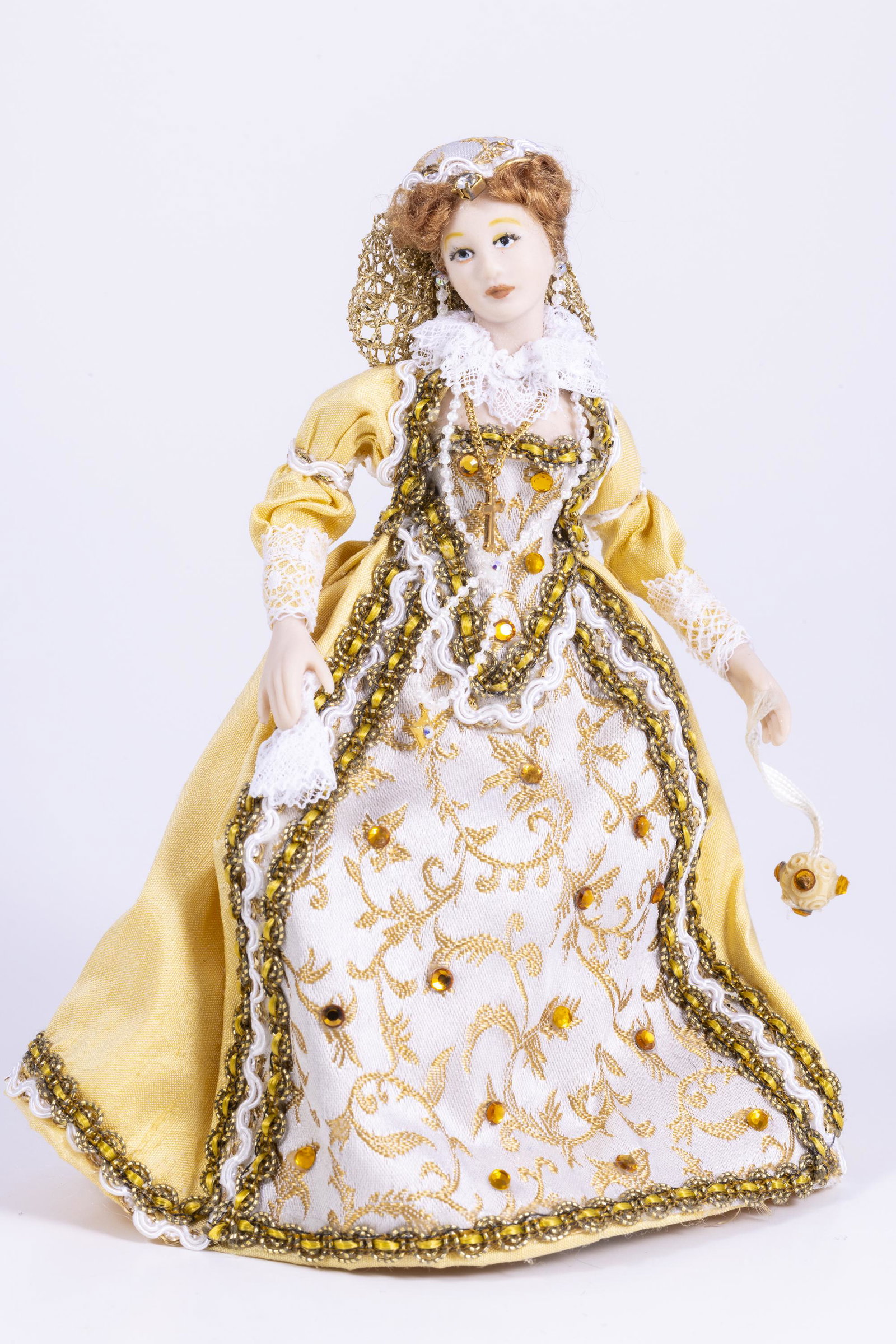 Elegantly Dressed Lady in 17th Century Elizabethan Dress: A beautifully dressed doll in gold and white with amber rhinestones, lots of jewelry and pretty auburn/reddish hair. She has a doll stand as well.