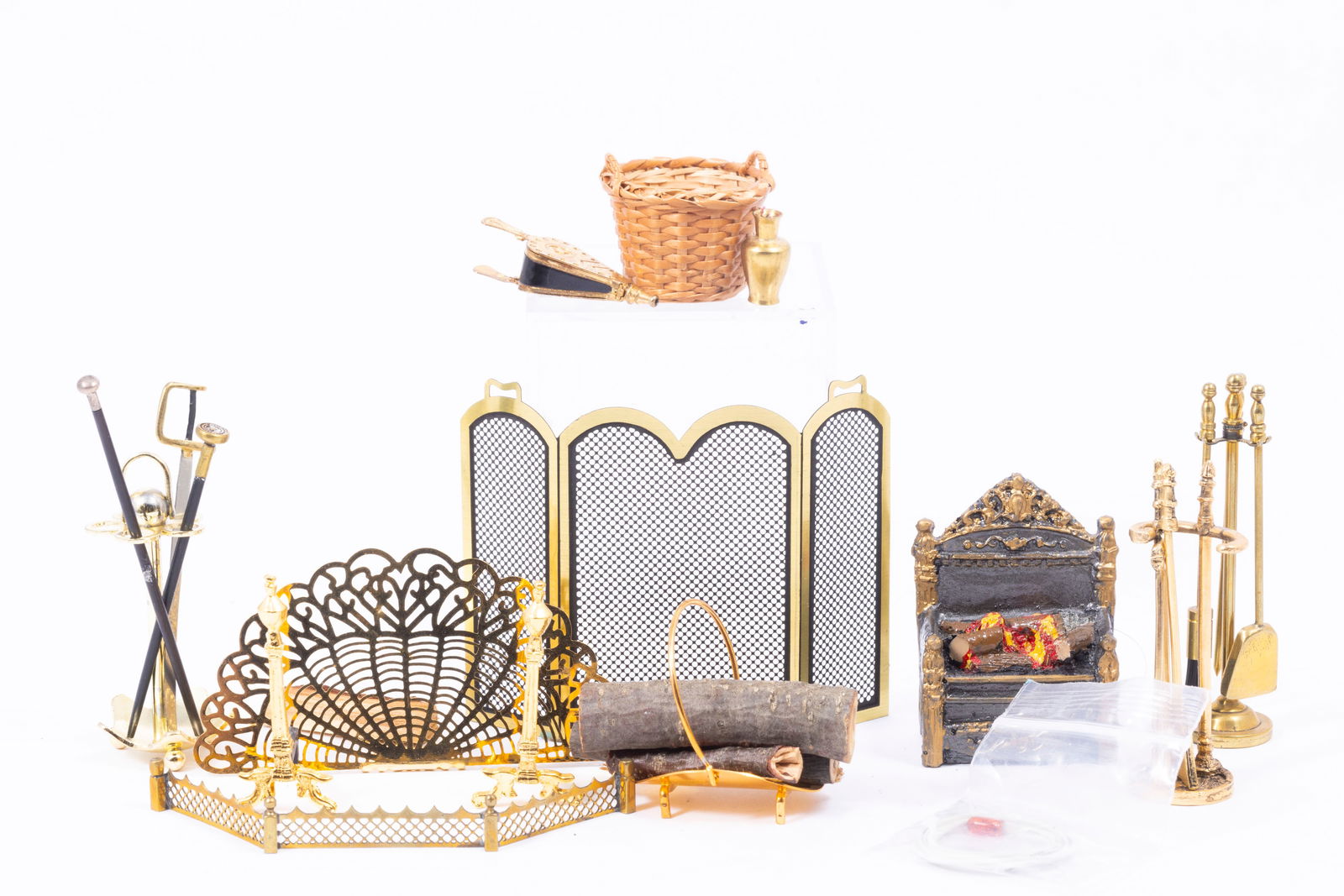Assortment of Fireplace Accessories & Canes: Fireplace accessories including a brass screen, brass fan screen, andirons, Reutter Porcelain bellows, basket with firewood, metal umbrella stand with a sword, two canes or walking sticks, and a fire