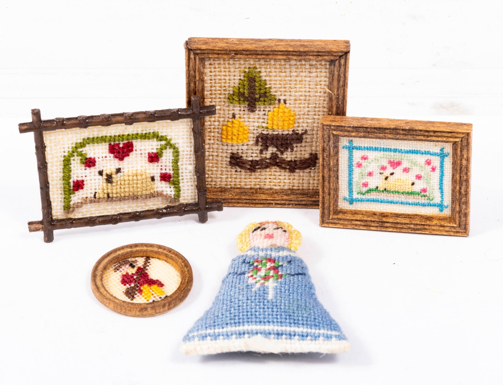 Needlepoint Pictures & Doll by Nancy Johnston: Little pictures of two needlepoint pictures with a sheep, Colonial man with rifle, Tree with a cow and fence, and a needlepoint doll. All made by Nancy Johnston.