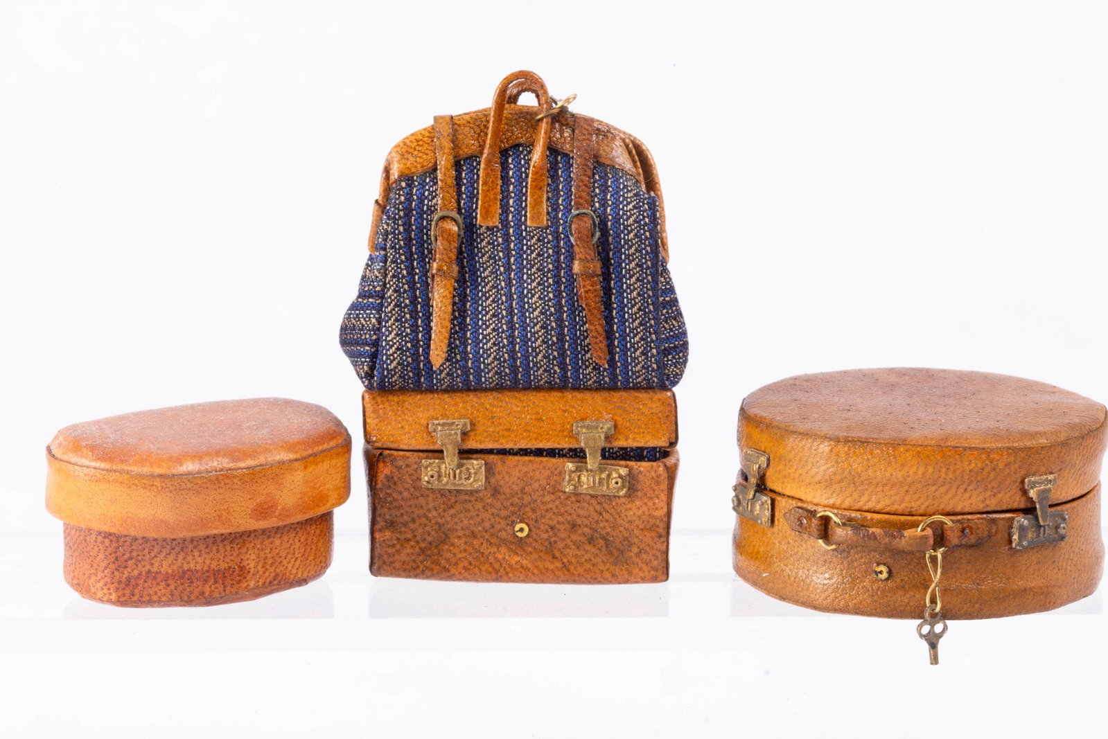 The Dolls Cobbler Luggage with LB: Dolls Cobbler Carpet Bag with Trunk as well as a round suitcase by The Dolls Cobbler. The oval piece is by LB.