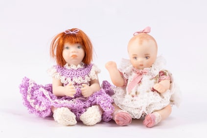 Two Little Porcelain Dolls in Crocheted Outfit