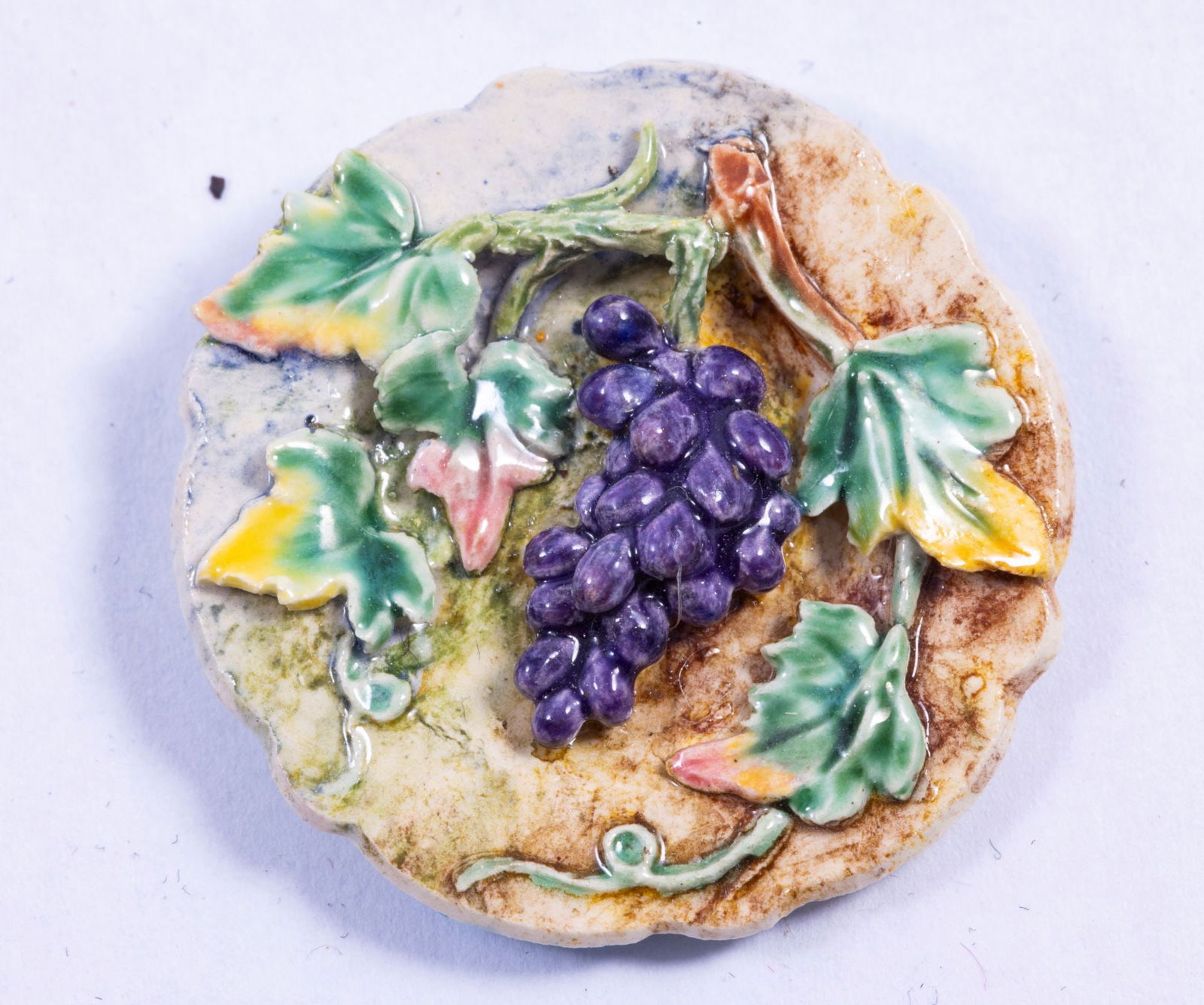 Dominique Levy Grapes Plate - Decorative Porcelain: Decorative porcelain plate by Dominique Levy. Purple grapes on a vine with grape leaves adorn the plate.