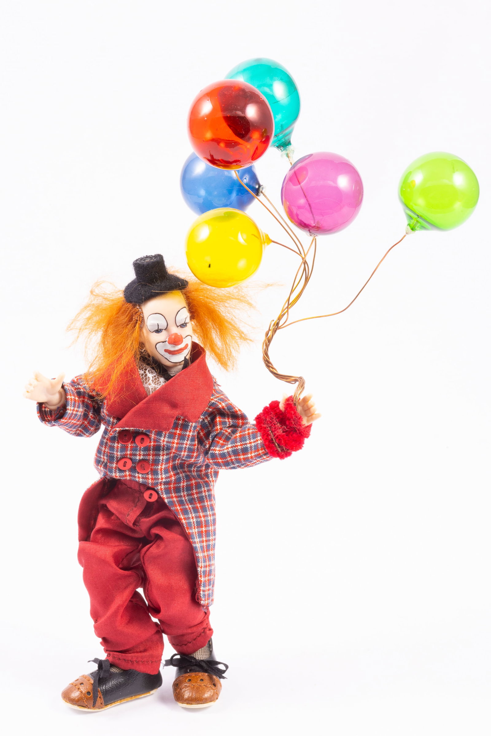Heidi Ot Clown Holding Balloons: Heidi Ott clown doll. He's holding a bunch of balloons. Balloons are wired around his wrist and attached.
