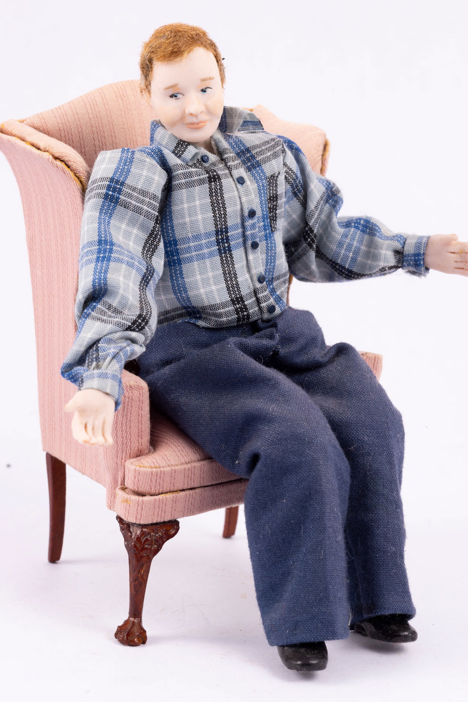 Fern Vasi Male Doll in Wingback Chair: Fern Vasi porcelain male doll in a wingback chair. He's attached to the cushion of the chair. He can cross his legs.