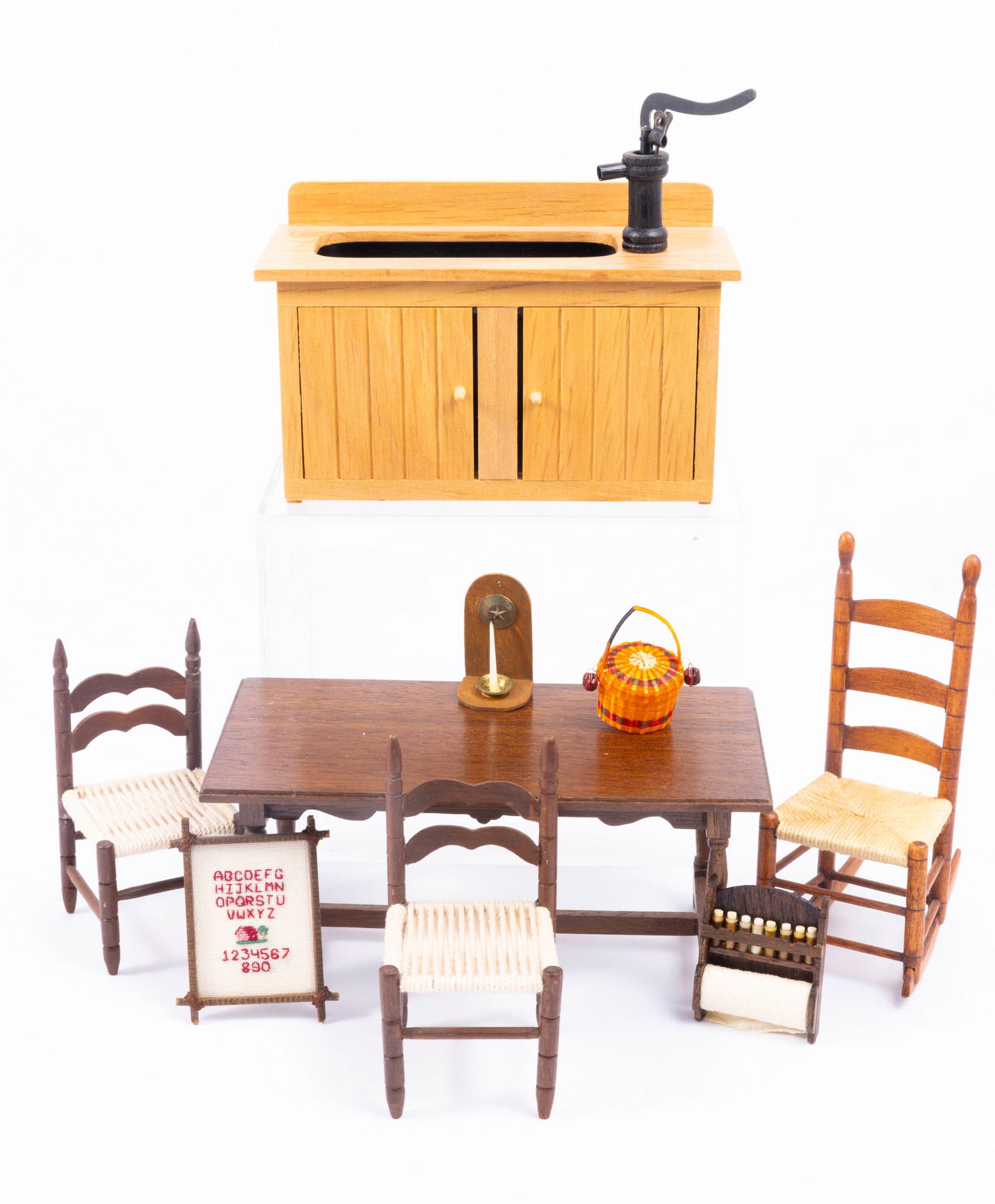 Kitchen Furniture & Needlepoint Picture - Vintage From Early 80's: Handmade dry sink with black pump. There's a handmade rocking chair with a rush seat and ladder back. The table is handmade and wooden, signature is hard to read. Two matching side chairs with rush se