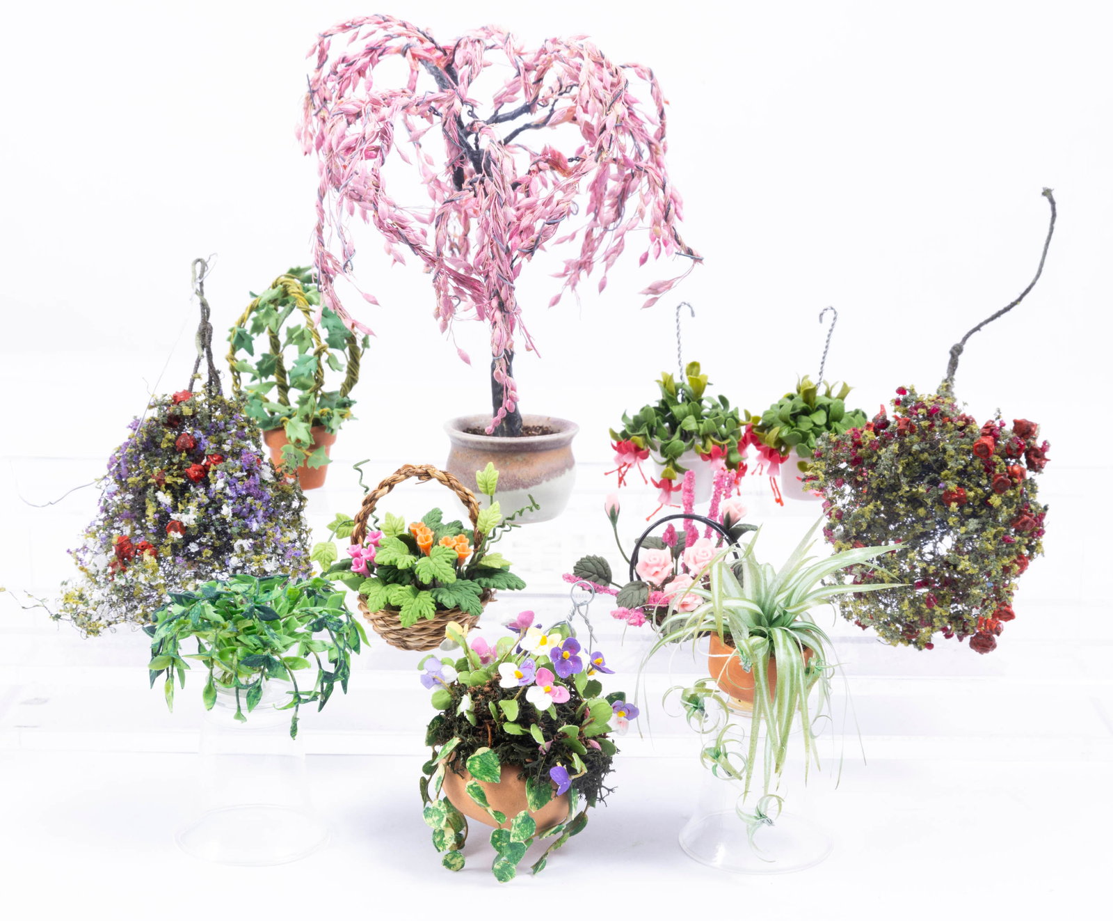 Pink Tree, Fuschia Plants & More Hanging Baskets: Pretty hanging plants including two Fuschia's and a pink tree. A nice assortment of other hanging flowers and plants.