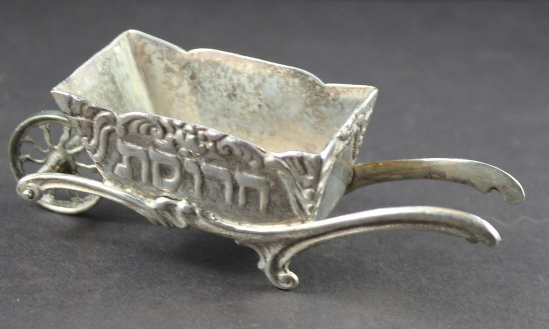 Judaica Sterling Passover Horseradish Holder: Sterling Wheel Barrel Horesradish Holder.-Marked 1 1/2"Ht. x 4 1/2"Long. Weight Over 2 1/2 ozt. Very Nice Collectors Item-Fine Condition.