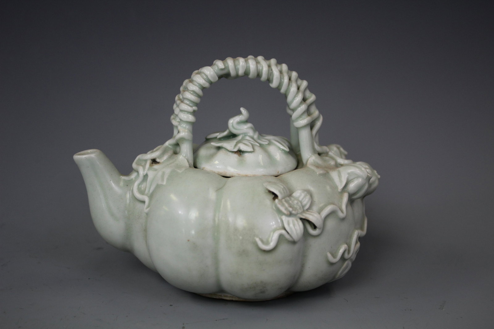 A Celadon-Glazed Embellished Kettle, Qing Dynasty: A Celadon-Glazed Embellished Kettle, Qing Dynasty