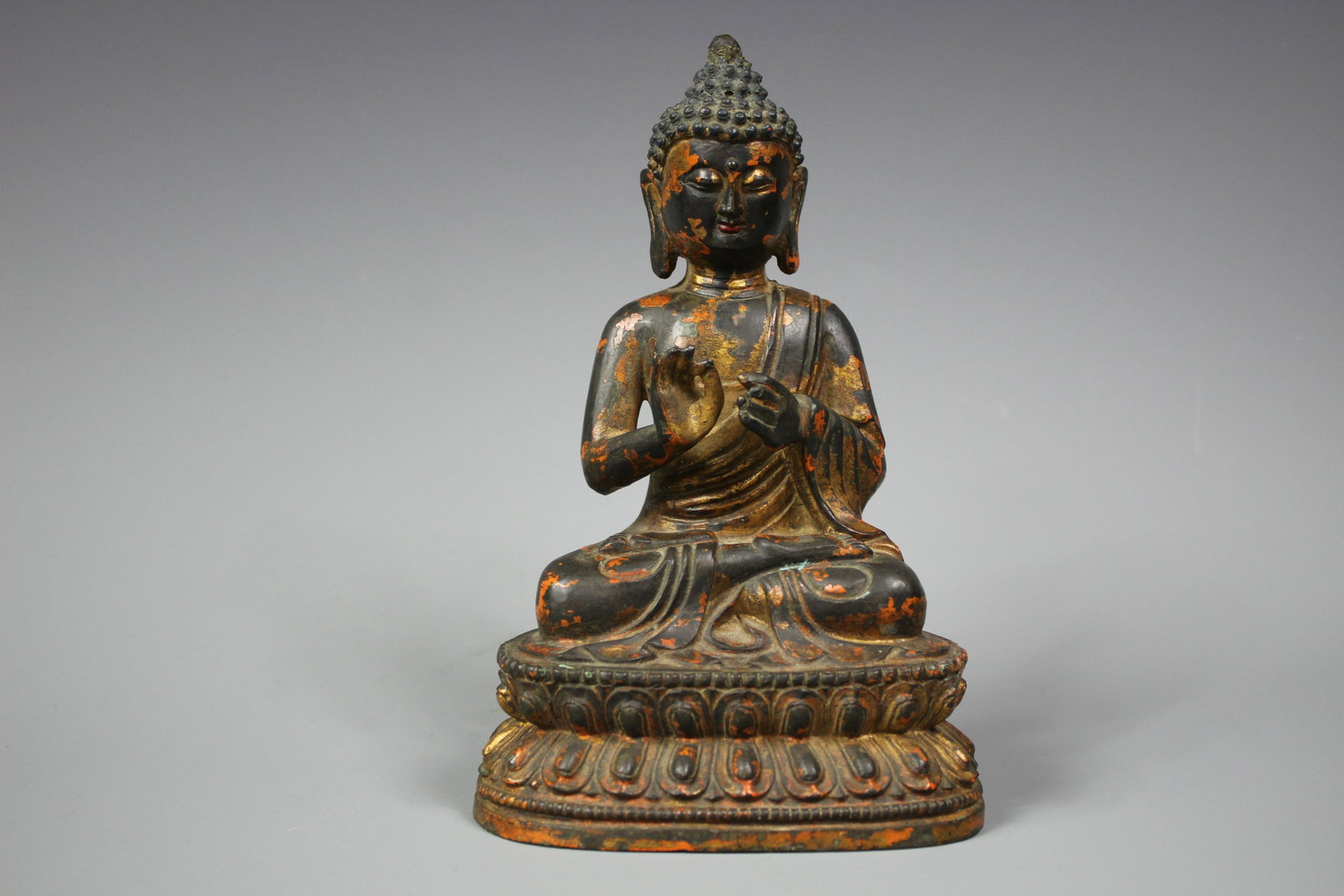 A Lacquered Parcel-Gilt Bronze Figure of Sakyamuni,: A Lacquered Parcel-Gilt Bronze Figure of Sakyamuni, Ming Dynasty 15th/16th Century