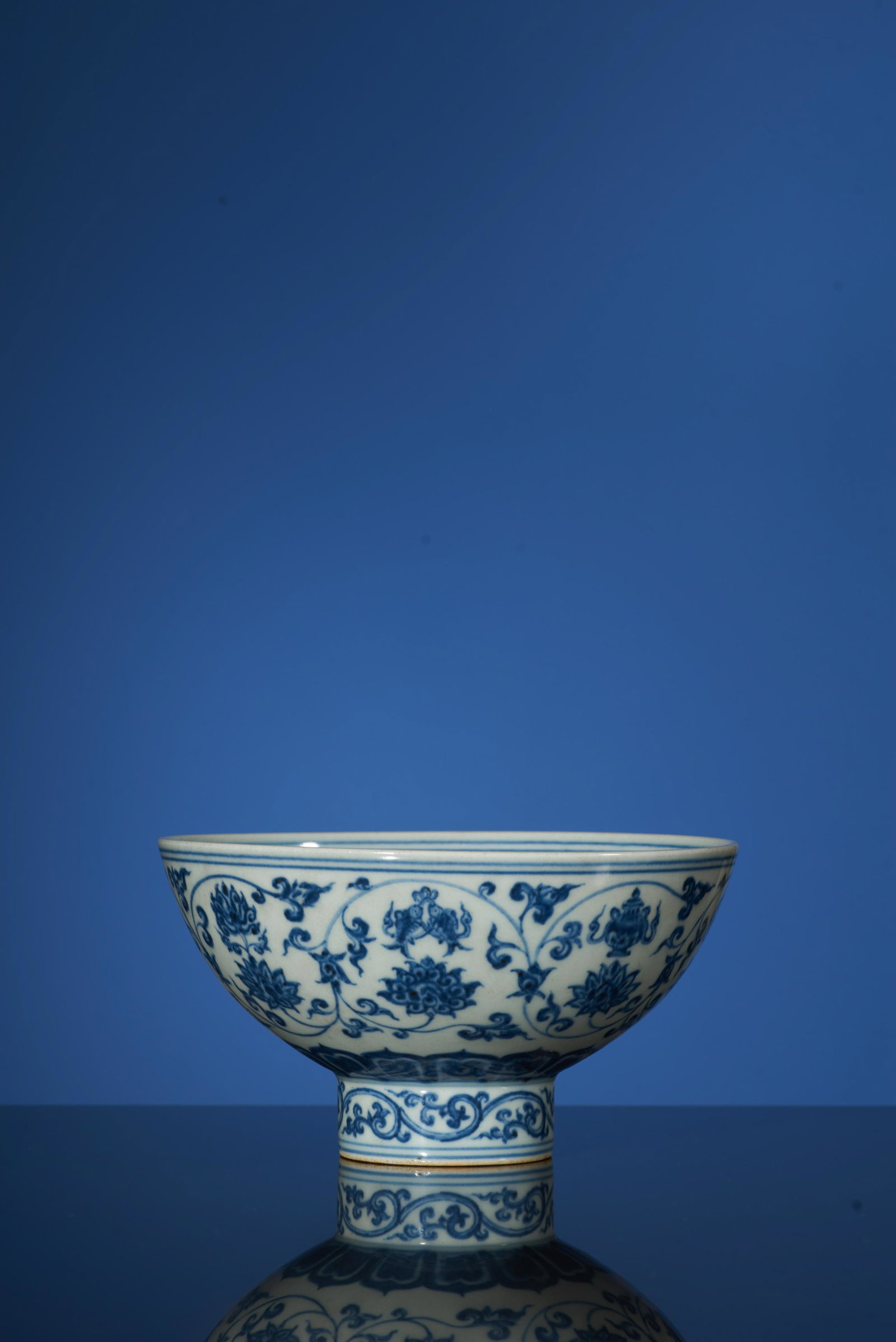 A Fine Blue and White ’LOTUS SCROLL’ Stem Bowl. XuanDe: A Fine Blue and White ’LOTUS SCROLL’ Stem Bowl. XuanDe Period, Ming Dynasty.