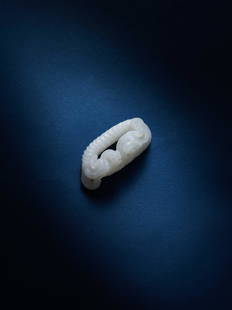 A WHITE JADE RING, HUAN, HAN (206 B.C.-220 A.D.): 漢 白玉蟠螭絞絲紋環 7.5 cm Length. 