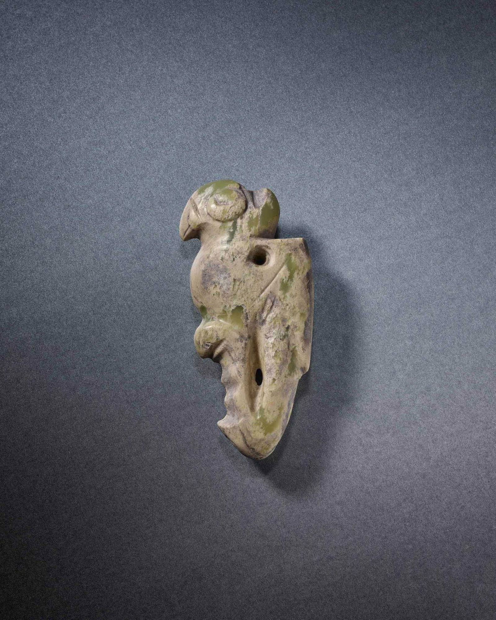 A CELADON JADE 'PARROT' ORNAMENT: 品名: 紅山文化 青玉鸚鵡柄形器。年代(Age):NEOLITHIC PERIOD。 尺寸:14.1 cm Length。