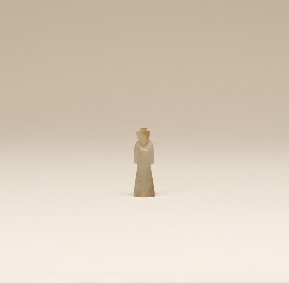 A JADE FIGURE: 品名(title):漢 玉翁仲。年代(Age): HAN (206 B.C.-220 A.D.)。 尺寸:2.9 cm Height。